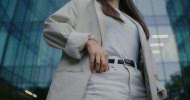 Kamera beyaz bir kadının etrafında hareket ediyor. Telefonunu cebinden çıkaran bir kadın. Cep telefonundaki ileti kontrol ediliyor. Uzaktan iletişim konsepti. İş kadını işe koşuyor..