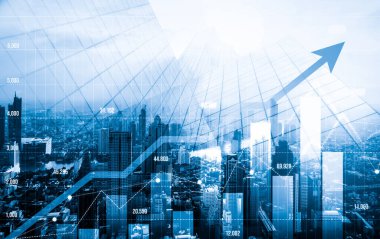 As background for a financial or business concept, digital screen and financial graphs overlap on a picture of modernistic cityscape, skyscrabbers.