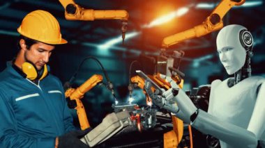 Cybernated industry robot and human worker working together in future factory . Concept of artificial intelligence for industrial revolution and automation manufacturing process .