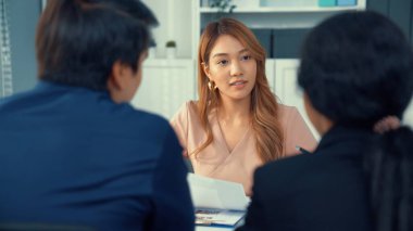 A young female asian candidate tries to impress her interviewer by being competent. International company, multicultural environment in workplace.