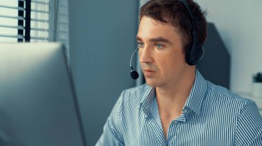 Competent male operator working with customers in the office. Concept of an operator, customer service agent working in the office.