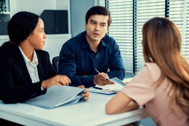 A young female asian candidate tries to impress her interviewer by being competent. International company, multicultural environment in workplace.