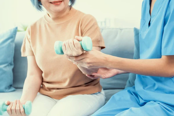 Caregiver Helping Contented Senior Woman Exercise Dumbbell Home Rehab Elder — Foto Stock