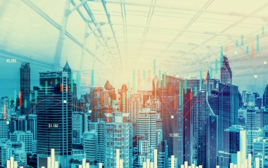 As background for a financial or business concept, digital screen and financial graphs overlap on a picture of modernistic cityscape, skyscrabbers.