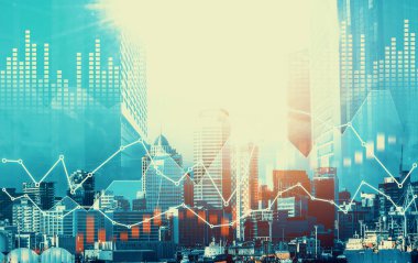 As background for a financial or business concept, digital screen and financial graphs overlap on a picture of modernistic cityscape, skyscrabbers.
