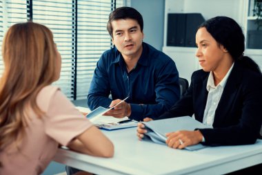A young female asian candidate tries to impress her interviewer by being competent. International company, multicultural environment in workplace.