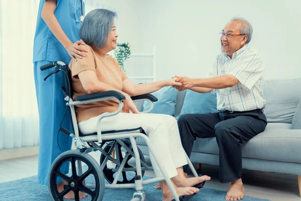 Contented Senior Couple Home Nurse Elderly Female Wheelchair Her Young — Foto de Stock