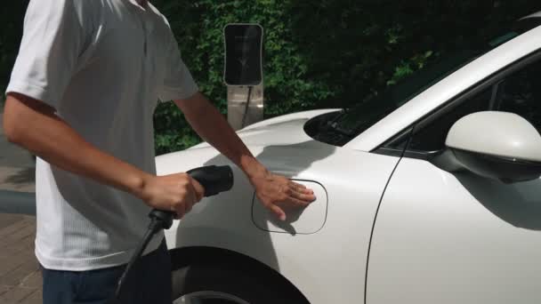 Progressive Man Install Power Cable Plug His Electric Vehicle Car — Stock Video