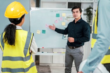 A team of investor and competent engineers brainstorming on the whiteboard to find new ideas and making plans. The idea of a team gather ideas together.