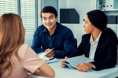 A young female asian candidate tries to impress her interviewer by being competent. International company, multicultural environment in workplace.