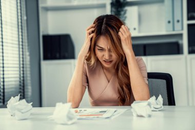 A competent female employee who has become completely exhausted as a result of overburdened work. Concept of unhealthy life as an office worker, office syndrome.