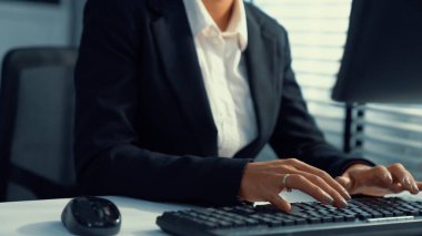 Competent female operator working on computer and talking with clients. Concept relevant to both call centers and customer service offices.