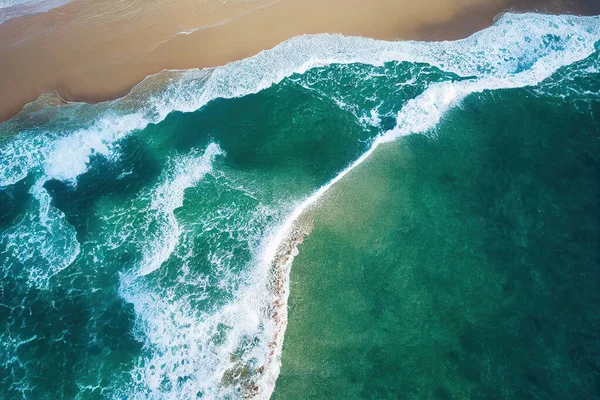 AI generated image top view from drone photo of beautiful beach with relaxing sunlight, sea water waves pounding the sand at the shore. Calmness and refreshing beach scenery.