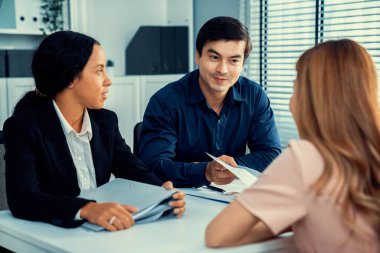 A young female asian candidate tries to impress her interviewer by being competent. International company, multicultural environment in workplace.