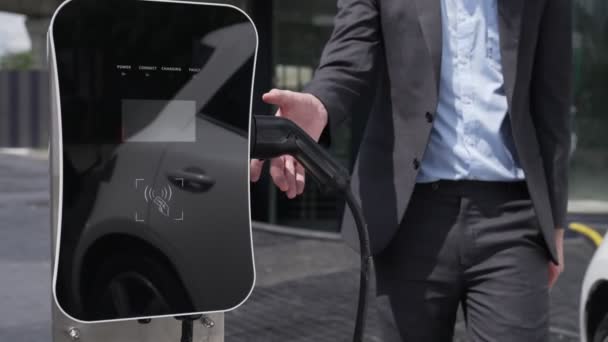 Progressive Businessman Install Charger Plug Charging Station His Electric Car — Stock Video