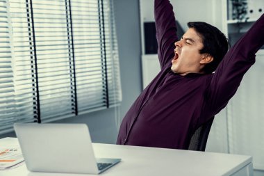 The exhausted asian office worker who was once competent is now confused. Overtime work is causing boredom and exhaustion in the workplace.