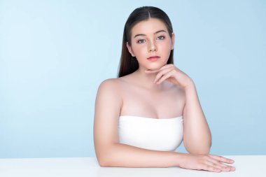 Portrait of young brunette with long hair and flawless skin with hand gesture for beauty and cosmetic concept. charming beautiful young girl posing hands for skincare or cosmetic advertising.