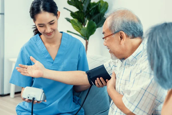 Elderly Man Having Blood Pressure Check His Personal Caregiver His — Stockfoto