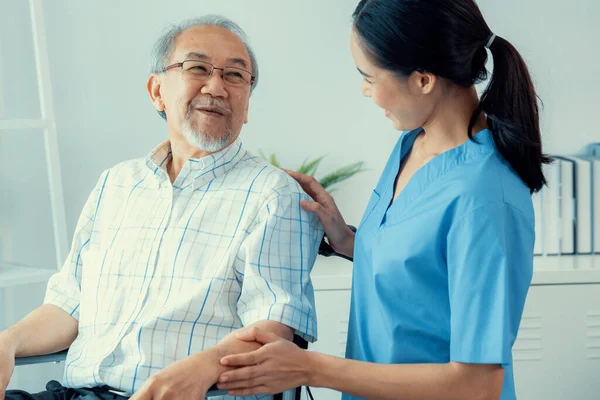 Happy Positive Asian Nurse Giving Support Touching Contented Senior Man — Fotografia de Stock