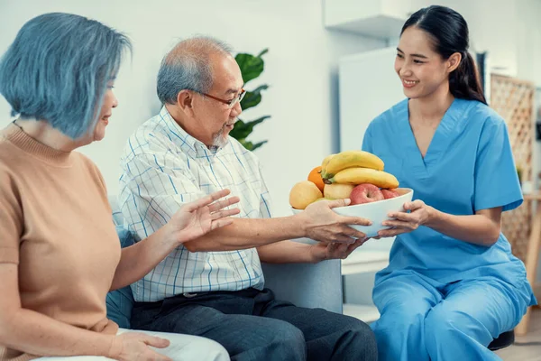 Contented Senior Couple Taking Bowl Fruit Nurse Home Senior Care —  Fotos de Stock