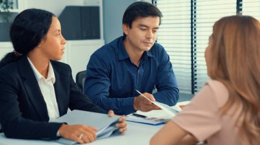 A young female asian candidate tries to impress her interviewer by being competent. International company, multicultural environment in workplace.