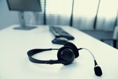 Close up image of headphones for competent online working. Customer service operator equipments.