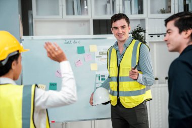 Entrepreneur brainstorming ideas with his competent engineers in the office. Architectural investors and engineers working on an upcoming project in a fun and friendly environment.