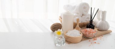 Spa accessory composition set in day spa hotel , beauty wellness center . Spa product are placed in luxury spa resort room , ready for massage therapy from professional service .