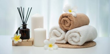 Spa accessory composition set in day spa hotel , beauty wellness center . Spa product are placed in luxury spa resort room , ready for massage therapy from professional service .