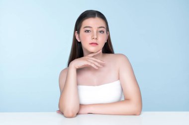 Portrait of young brunette with long hair and flawless skin with hand gesture for beauty and cosmetic concept. charming beautiful young girl posing hands for skincare or cosmetic advertising.