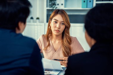 A young female asian candidate tries to impress her interviewer by being competent. International company, multicultural environment in workplace.