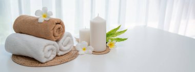 Spa accessory composition set in day spa hotel , beauty wellness center . Spa product are placed in luxury spa resort room , ready for massage therapy from professional service .