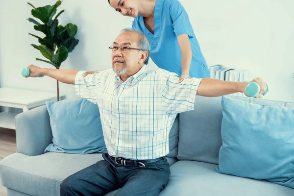 Contented Senior Patient Doing Physical Therapy Help His Caregiver Senior — Stockfoto