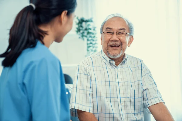 Young Female Doctor Inquires Personal Information Contented Senior Home Medical — Stockfoto