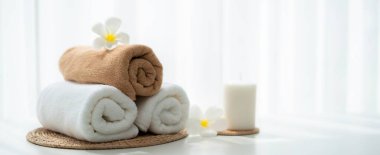 Spa accessory composition set in day spa hotel , beauty wellness center . Spa product are placed in luxury spa resort room , ready for massage therapy from professional service .