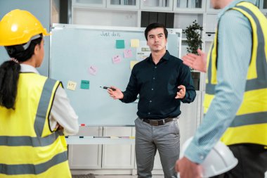 A team of investor and competent engineers brainstorming on the whiteboard to find new ideas and making plans. The idea of a team gather ideas together.