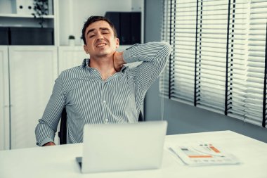 Competent office worker experiencing fatigue and neck pain. Unhealthy concept for office workers, office syndrome.