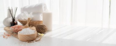 Spa accessory composition set in day spa hotel , beauty wellness center . Spa product are placed in luxury spa resort room , ready for massage therapy from professional service .