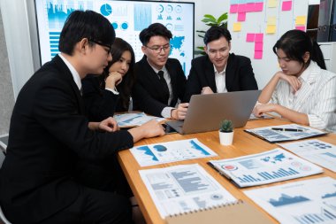 Business team of financial data analysis meeting with business intelligence, report paper and dashboard on laptop for marketing strategy. Business people working together to promote harmony in office.