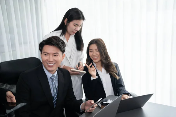 stock image Harmony in office concept as business people analyzing dashboard paper together in workplace. Young colleagues give ideas at manager desk for discussion or strategy planning about project.