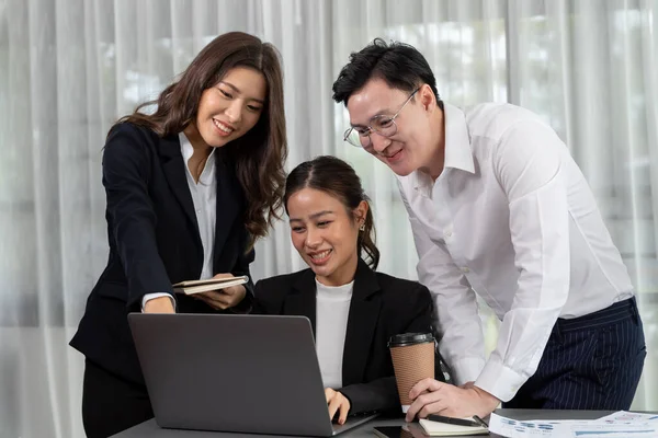 stock image Harmony in office concept as business people analyzing dashboard paper together in workplace. Young colleagues give ideas at manager desk for discussion or strategy planning about project.