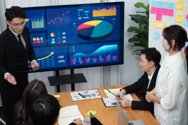 Confidence and asian businessman give presentation on financial analyzed by business intelligence in dashboard report to other people in board room meeting to promote harmony in workplace.
