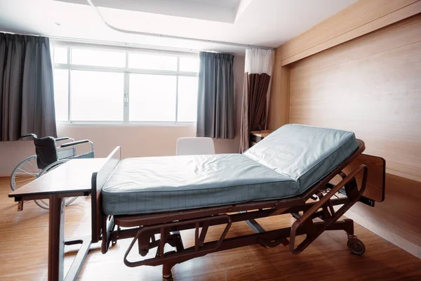 Sterile recovery room equipped with comfortable modern medical sickbed for patient recovery. Photo of a hospital bedroom or ward for patient treatment for medical usage.