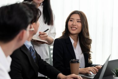 Focus portrait of female manger, businesswoman in the harmony meeting room with blurred of colleagues working together, analyzing financial paper report and dashboard data in background.