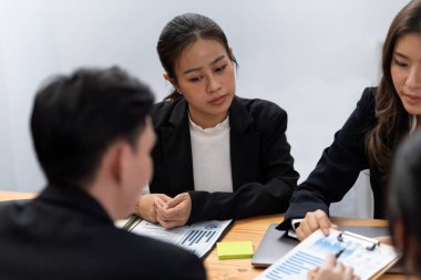 Business team of financial data analysis meeting with business intelligence, report paper and dashboard on laptop for marketing strategy. Business people working together to promote harmony in office.