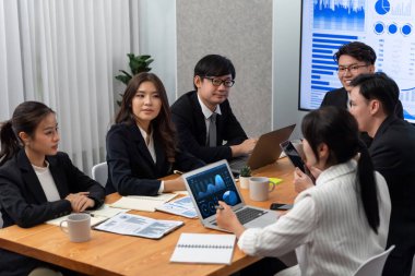 Business team of financial data analysis meeting with business intelligence, report paper and dashboard on laptop for marketing strategy. Business people working together to promote harmony in office.