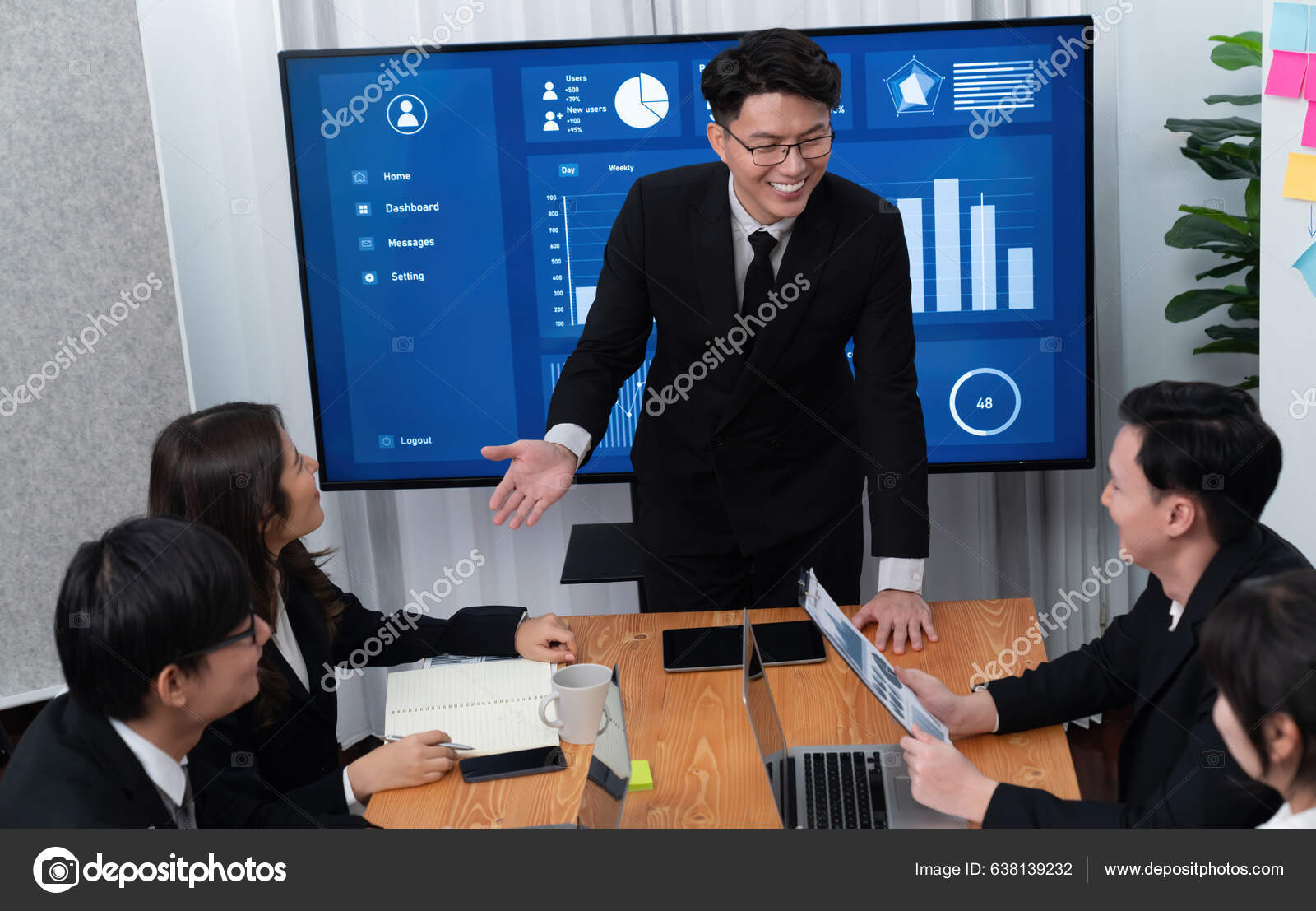A person giving a presentation at work, confidently gesturing towards a graph on a screen.
