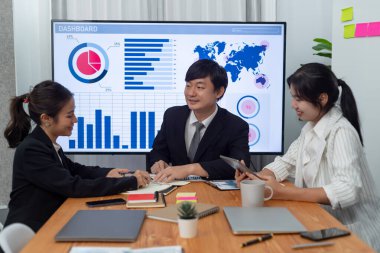 Business team of financial data analysis meeting with business intelligence, report paper and dashboard on laptop for marketing strategy. Business people working together to promote harmony in office.