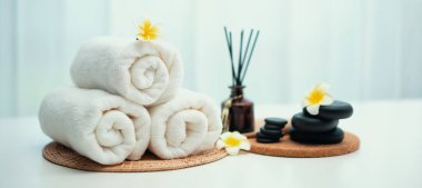 Spa accessory composition set in day spa hotel , beauty wellness center . Spa product are placed in luxury spa resort room , ready for massage therapy from professional service .