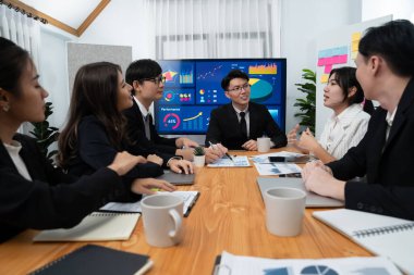 Business team of financial data analysis meeting with business intelligence, report paper and dashboard on laptop for marketing strategy. Business people working together to promote harmony in office.